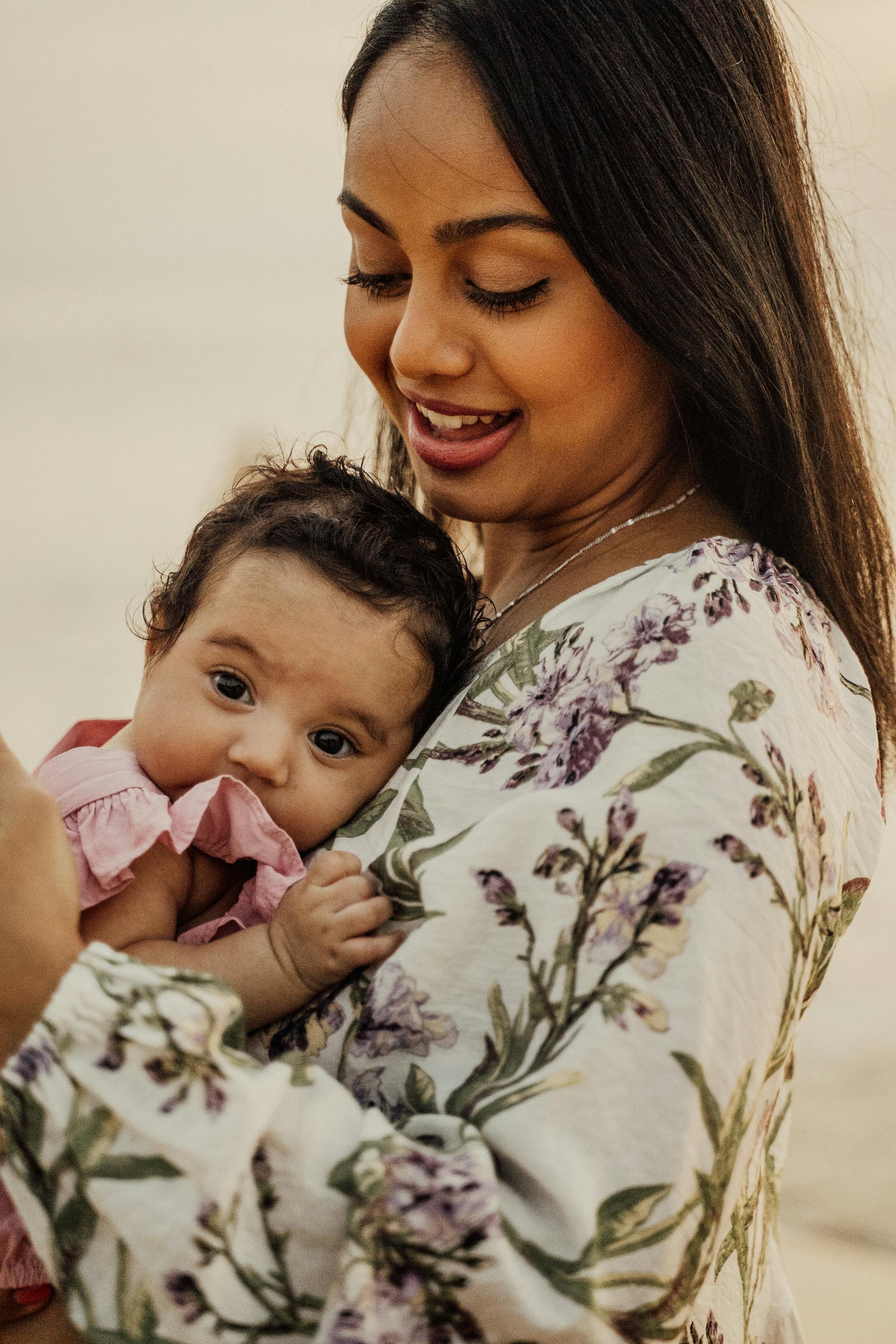 Hawaiian Pacific Islander mother cradling her infant